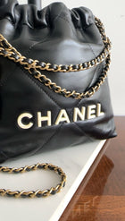 Chanel 2023 Black Leather Chain 22 Mini Bag with Ivory Enamel Logo