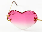Cartier heart-shaped sunglasses with pink gradient lenses on a white background