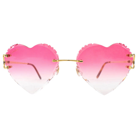 Heart-shaped sunglasses with pink gradient lenses on a white background