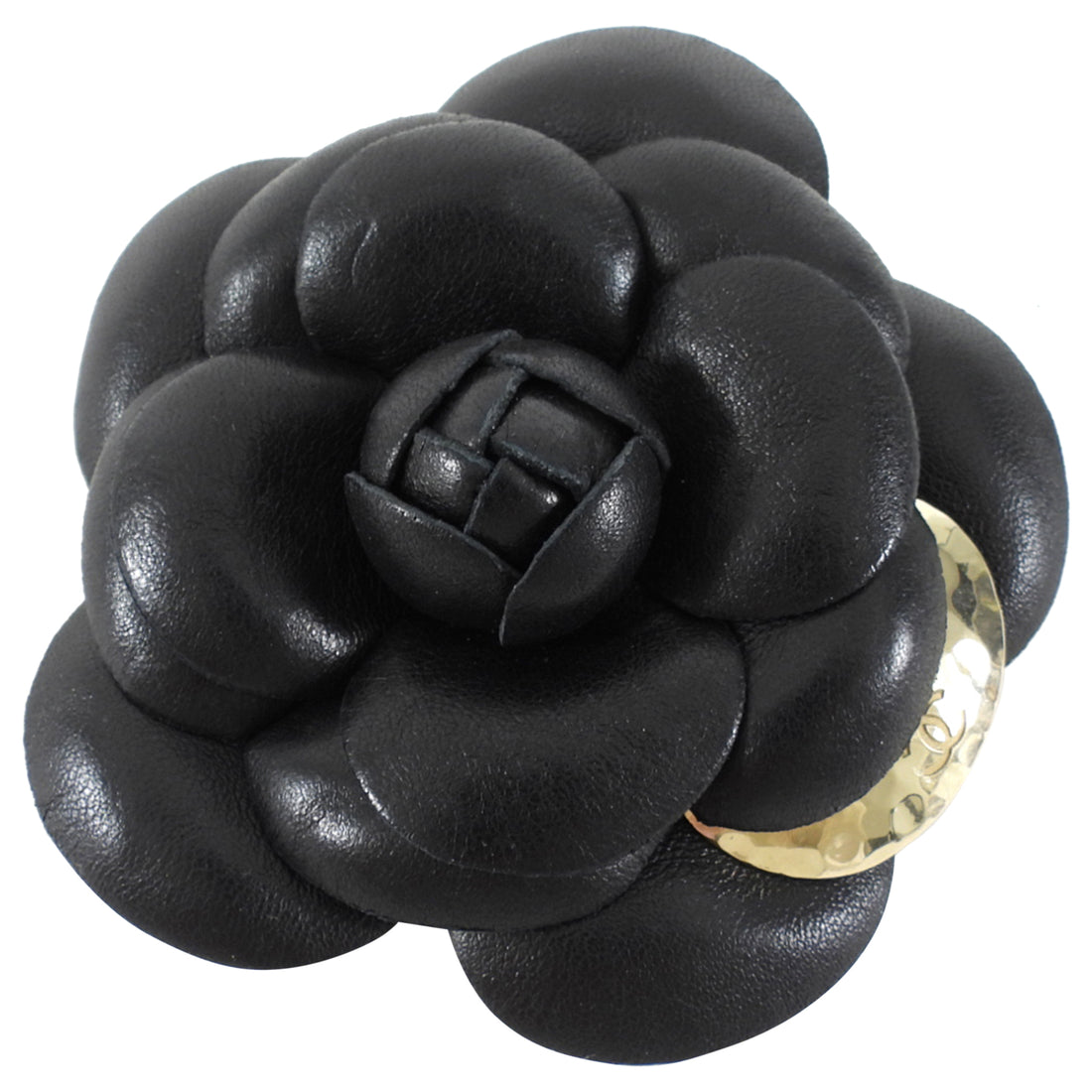 Black leather flower-shaped brooch with a gold accent on a white background