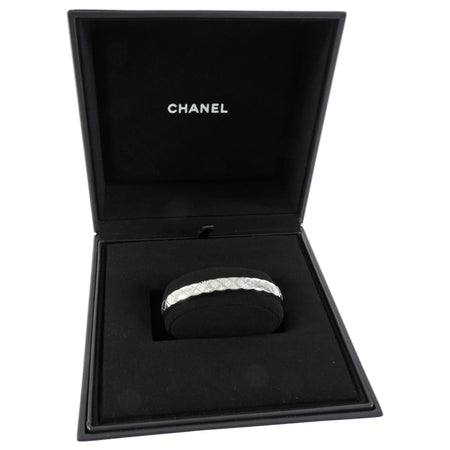 Chanel jewelry box with coco crush diamond bracelet inside on a white background