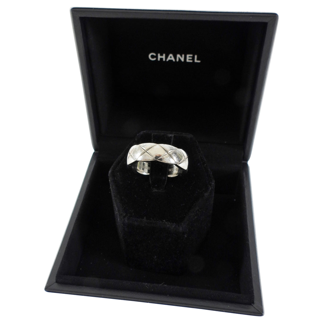 Silver ring in a Chanel jewelry box on a white background
