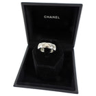 Silver ring in a Chanel jewelry box on a white background