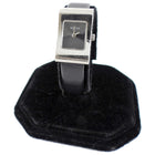 Gucci watch on a black stand with a white background
