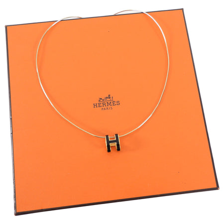 Hermes necklace on an orange Hermes packaging box