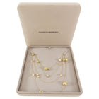 Gold necklace in a Marco Bicego box on a white background