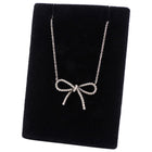 Tiffay & co. Silver bow-shaped necklace on a black velvet stand