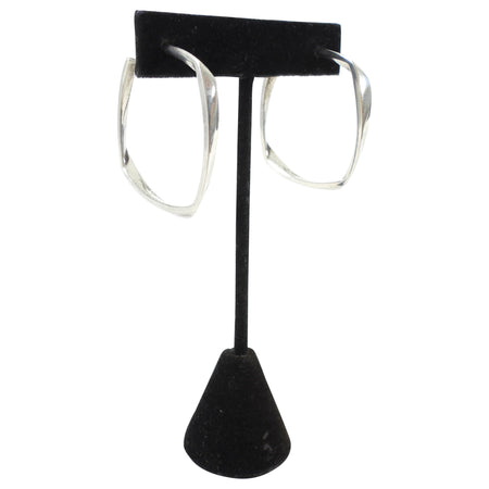 Tiffany & Co. x Frank Gehry Silver hoop earrings on a black earring stand against a white background