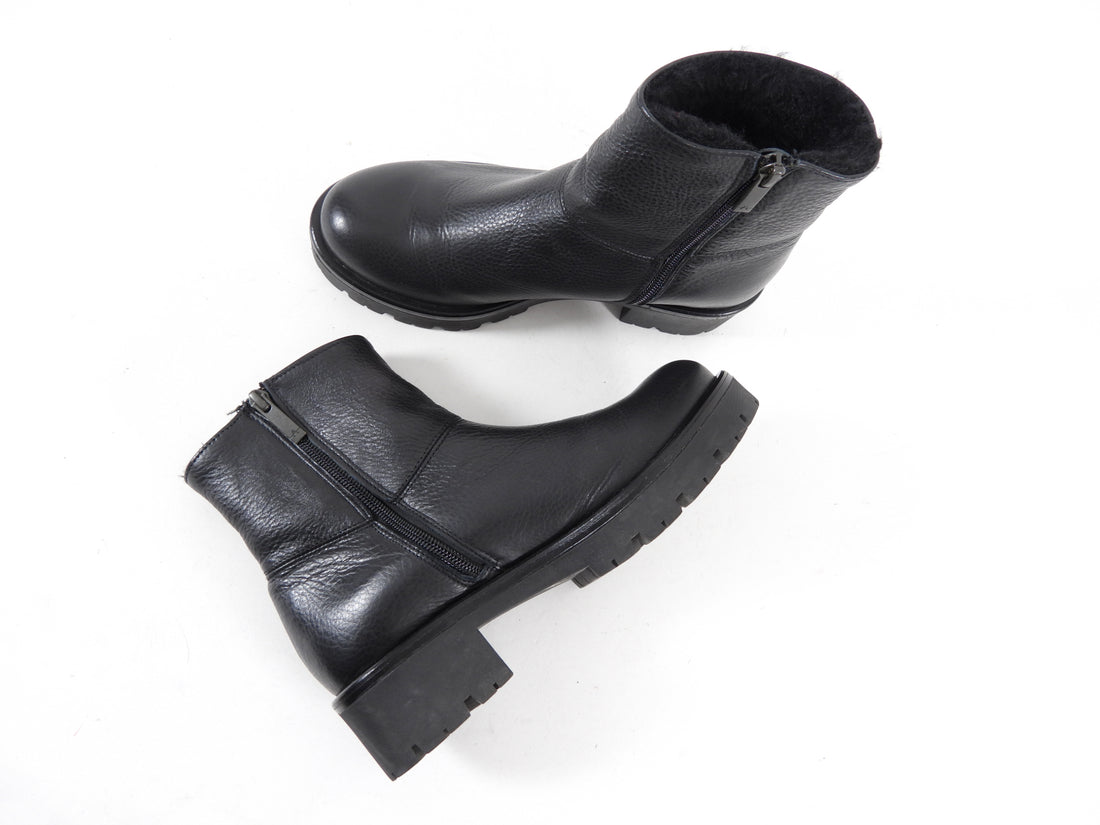 Aquatalia Black Leather Shearling Ankle Boots.  Round toe, rubber track sole, interior ankle zipper, and shearling lined interior.  Size 37.  Excellent gently pre-owned condition.  Without box or duster.