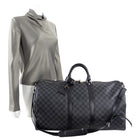 Sold at Auction: A designer duffle bag marked Louis Vuitton with dust bag,  strap & luggage tag