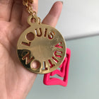 Louis Vuitton Pink Acrylic and Gold Logo Medallion Key Chain