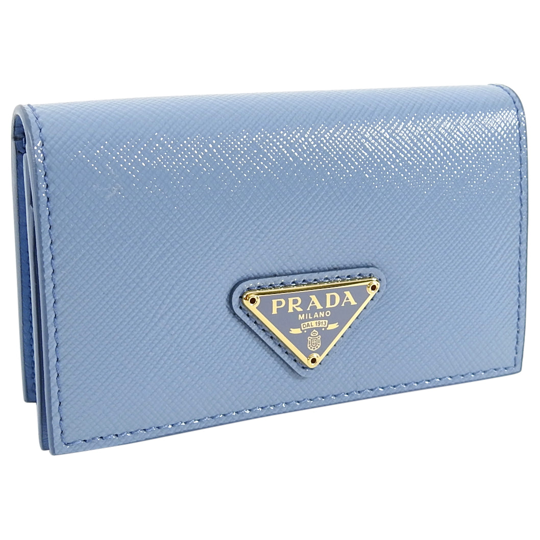 PRADA: Small recognizable logo with much space around a soft grey blue card