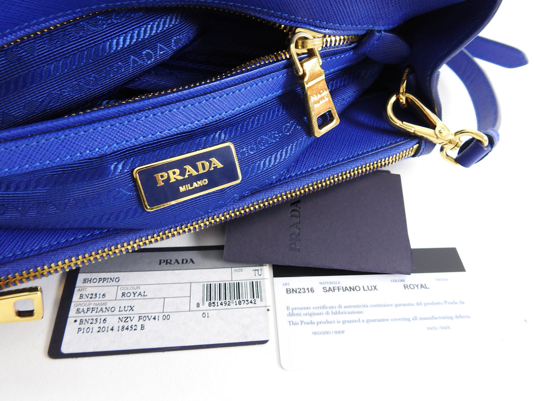 Prada Saffiano Cobalt Blue Mini Galleria Tote Bag.  Current original retail price is $2550 CAD. Goldtone metal hardware, logo at front, double handles, double zippered compartment, clochette, long shoulder strap.  Measures 10.25 x 7 x 4” with a 23” strap drop.  Includes authenticity card and care paper. 